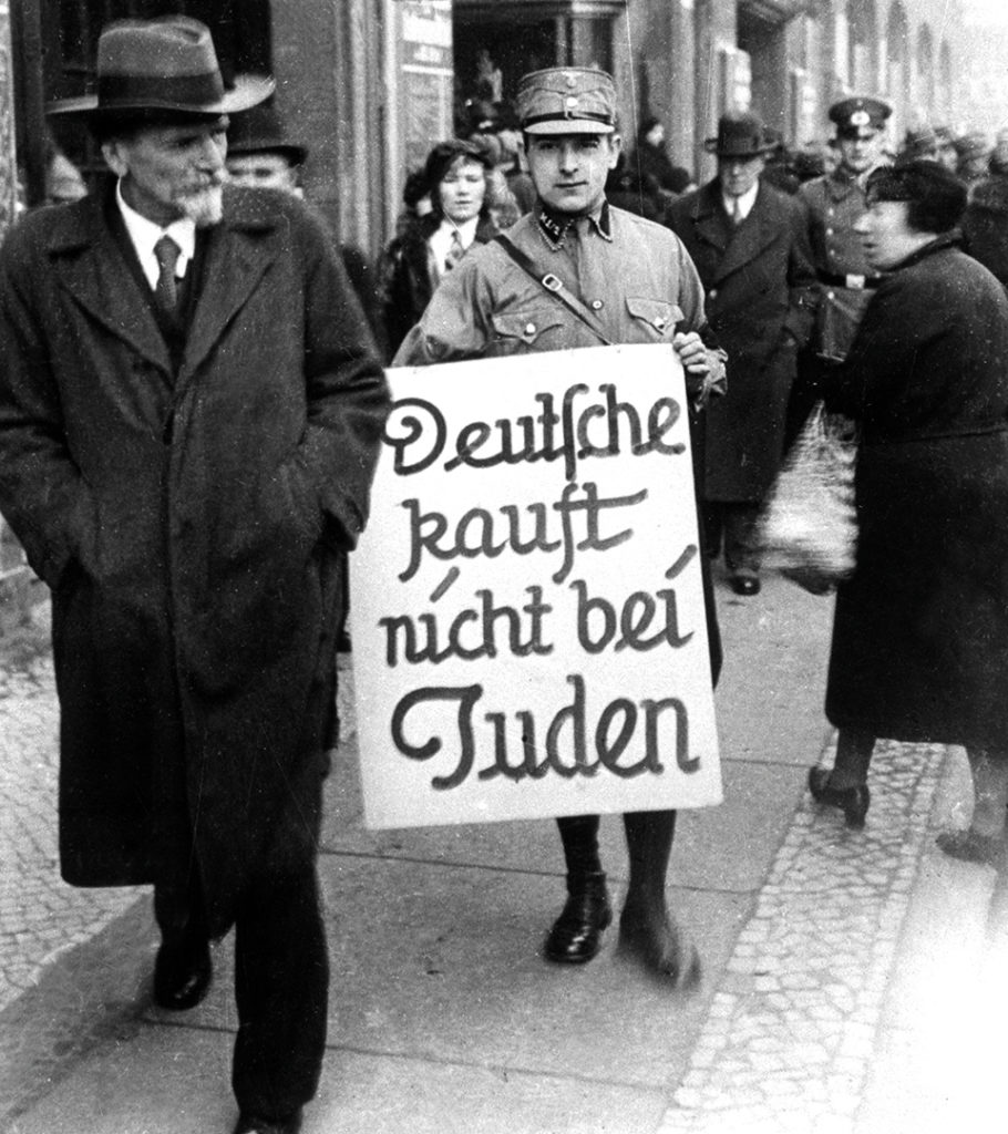 SA-Mann mit einem Schild mit der Aufschrift: Deutsche kauft nicht bei Juden